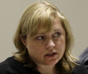 In this March 15, 2016 photo, Ferguson city attorney Stephanie Karr participates in a city council meeting in Ferguson, Mo. Karr, who had been criticized by the federal investigation of Ferguson's justice system after the police shooting death of Michael Brown, announced her resignation as Ferguson city attorney Monday, May 23, 2016, just weeks after the city announced they were removing her as local prosecutor a position she also held. (AP Photo/Jeff Roberson)