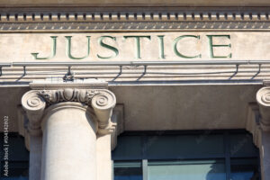 Justice sign on a Courthouse Building.
