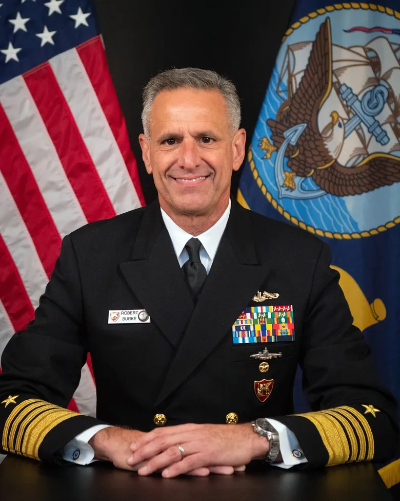 A smiling man in a military uniform with medals.