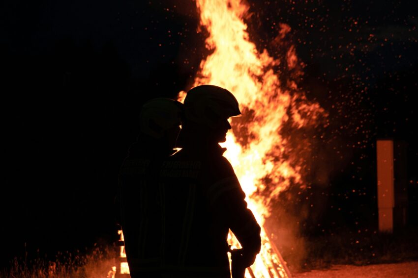 Firefighters in front of a huge fire.