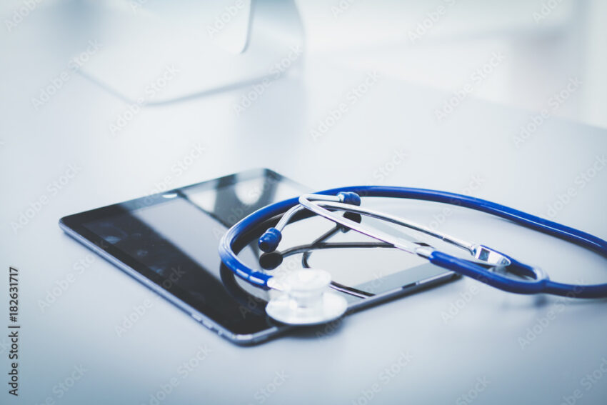 Medical equipment: blue stethoscope and tablet on white background. Medical equipment