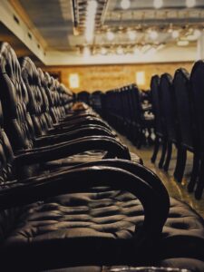 tufted black chairs inside building with no people