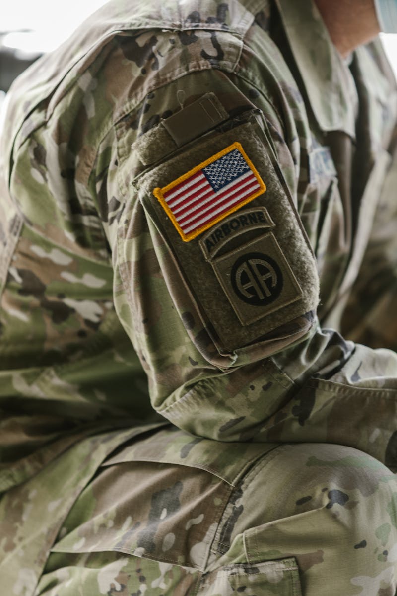 Detailed close-up of a military uniform sleeve featuring an American flag patch.