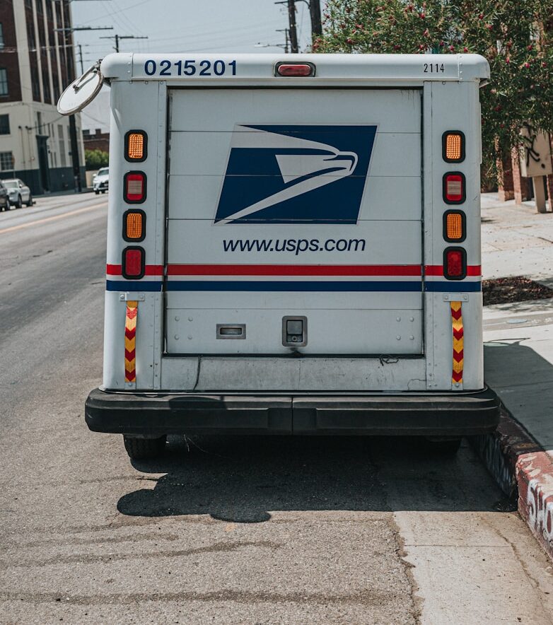 a mail truck parked on the side of the road
